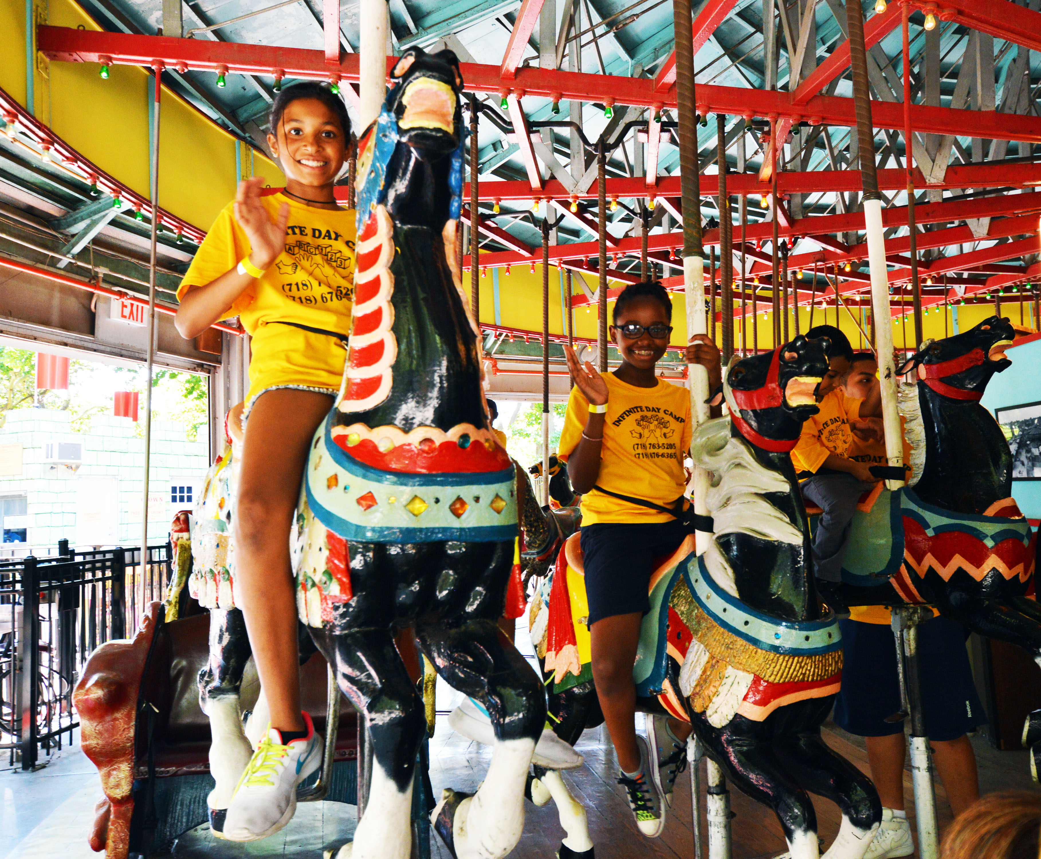 Image of kids riding the Flushing Meadows Carousel.